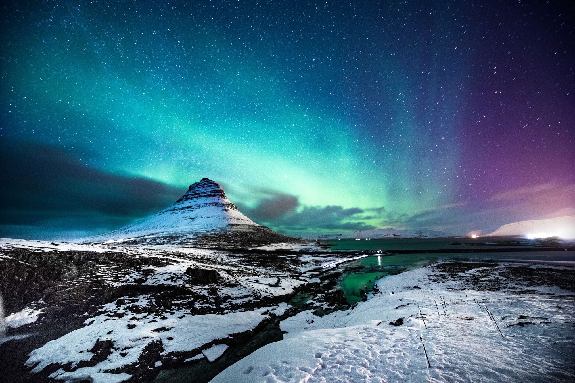 A view of the Northern Lights over a snowy landscape