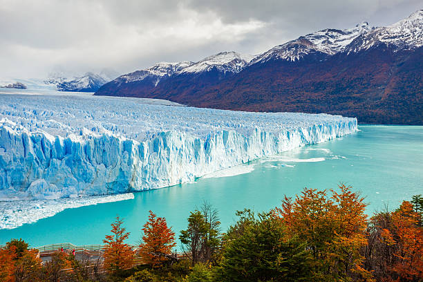 A massive blue glacier nestled between sharp mountains